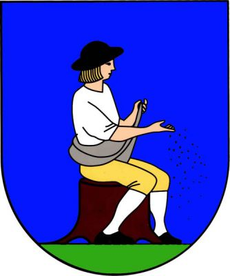 V modrém štítě rozsévač s černým kloboukem a botami, stříbrnou košilí a punčochami a zlatými spodky sedící doleva na pařezu přirozené barvy na zeleném trávníku. Znak Horní Újezd