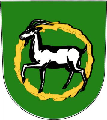 V zeleném štítě ve zlatém věnci stříbrný kráčející kozel. Znak Kozojídky
