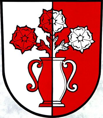 Ve stříbrno-červeně polceném štítě dvouuchá váza se třemi růžemi na jednom stonku, vše opačných barev. Znak Malé Hoštice