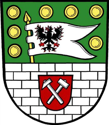 V zeleném štítě stříbrná kvádrovaná zeď s červeným štítkem se stříbrnými hornickými kladívky, z níž vyrůstá na zlaté žerdi stříbrný praporec se dvěma cípy s černou plamennou orlicí s červenou zbrojí, provázený podél okrajů štítu sedmi zlatými knoflíky. Znak Předín
