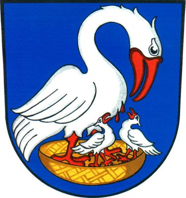 V modrém štítě doleva obrácený pelikán krmící ve zlatém hnízdě krví ze své hrudi dvě mláďata. Všichni stříbrní s červenou zbrojí. Znak Suché Lazce